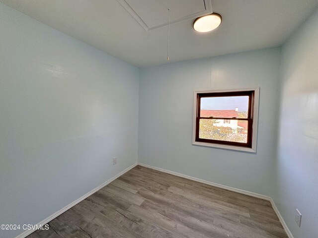 112 Green St, Edwardsville, PA 18704 - unfurnished room featuring attic access, baseboards, and wood finished floors