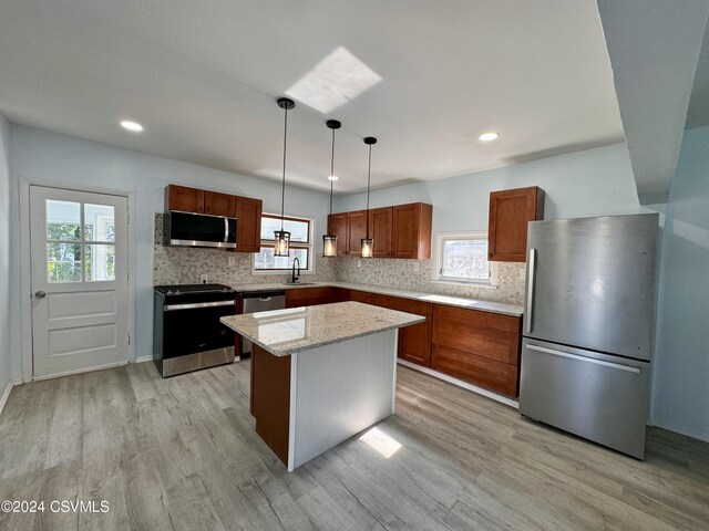 112 Green St, Edwardsville, PA 18704 - kitchen with tasteful backsplash, stainless steel appliances, and light wood finished floors
