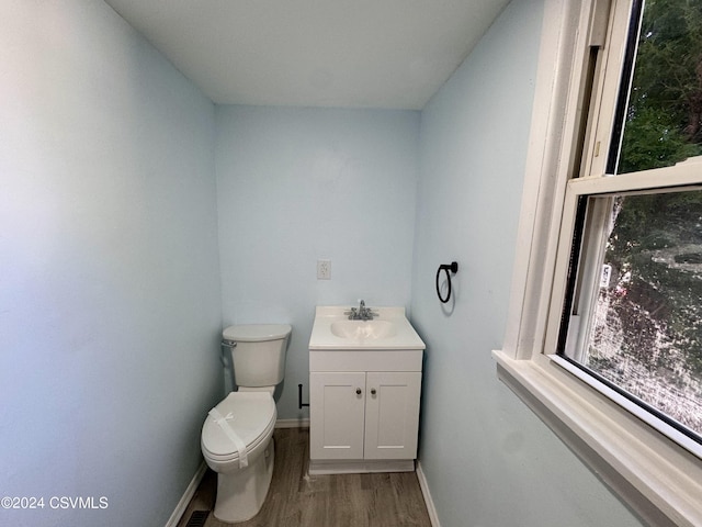 112 Green St, Edwardsville, PA 18704 - bathroom featuring baseboards, wood finished floors, toilet, and vanity