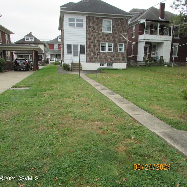 exterior space with a front lawn and a carport