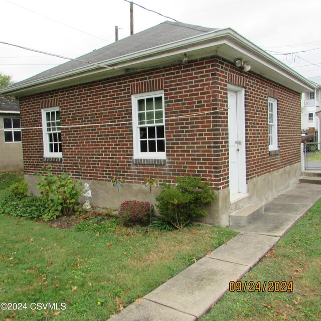 view of property exterior with a yard