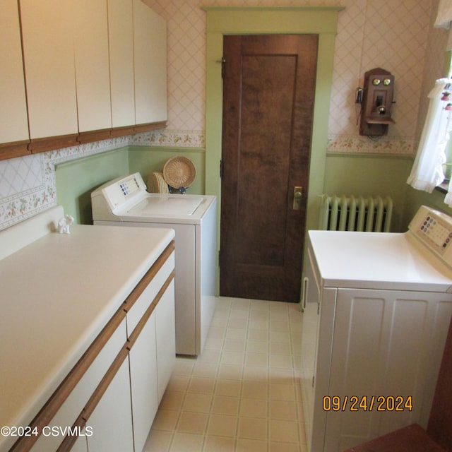 laundry room with light tile patterned floors, cabinets, independent washer and dryer, and radiator heating unit