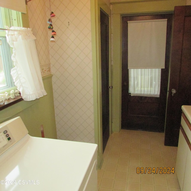 bathroom featuring tile patterned flooring and washer / clothes dryer