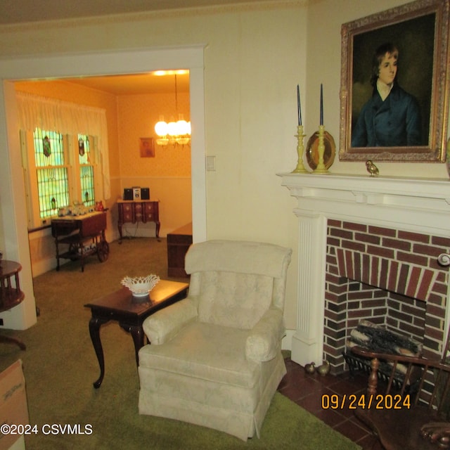 sitting room featuring carpet flooring, an inviting chandelier, and a brick fireplace