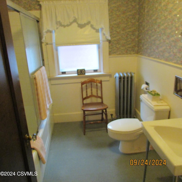 bathroom featuring tub / shower combination, radiator, and toilet