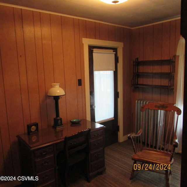 carpeted office space with wood walls