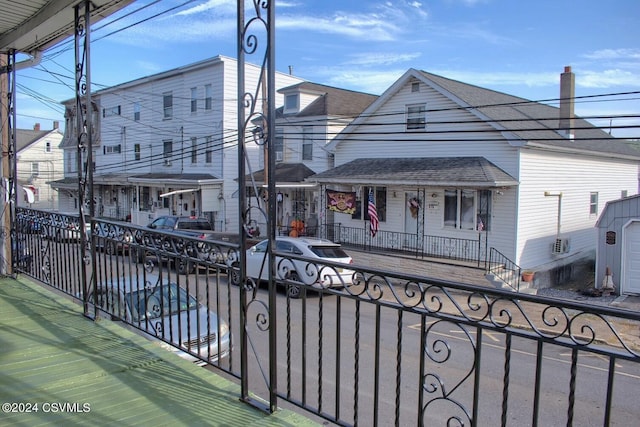 view of front of house with a porch and an outbuilding