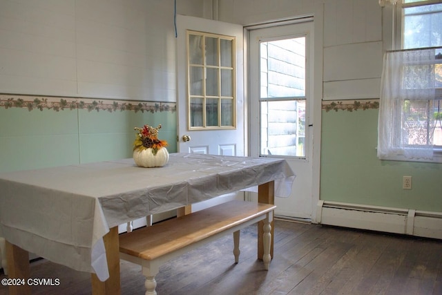 dining room featuring baseboard heating and dark hardwood / wood-style flooring