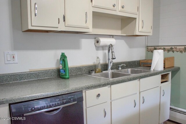 kitchen featuring a baseboard heating unit, white cabinetry, sink, and dishwashing machine