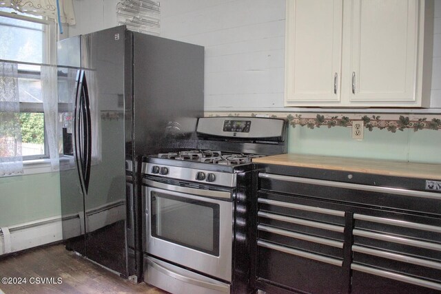 kitchen featuring gas stove, white cabinetry, dark hardwood / wood-style floors, and plenty of natural light