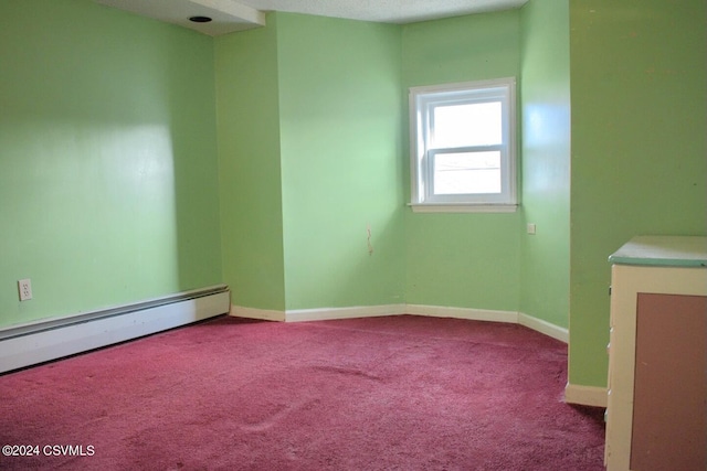 carpeted spare room featuring a textured ceiling and baseboard heating