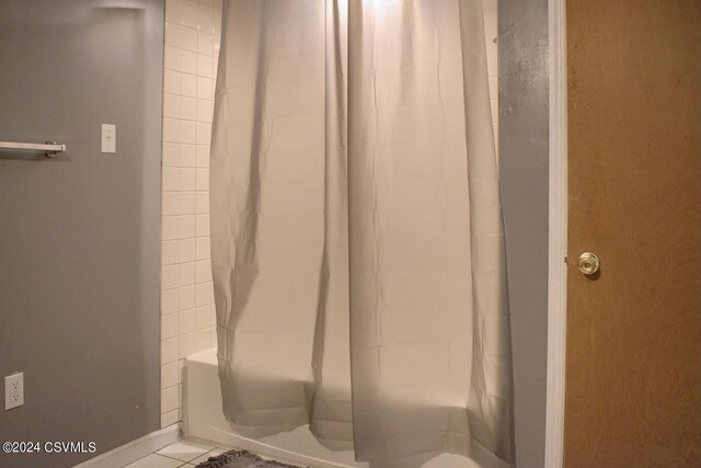 bathroom featuring tile patterned floors and shower / bath combo