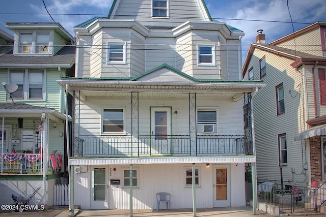 view of front of house featuring a balcony