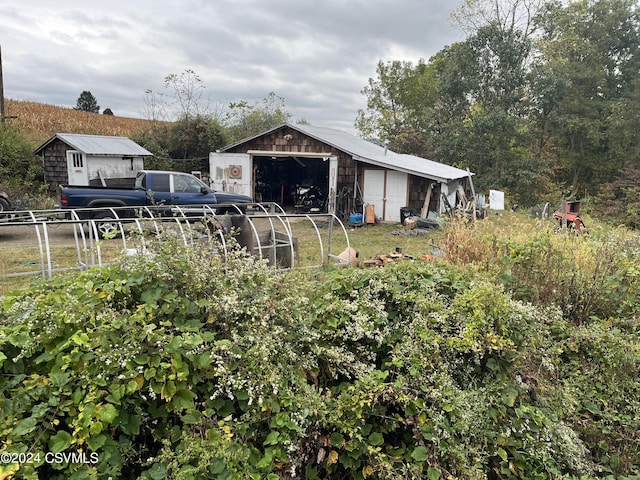 view of outdoor structure with an outbuilding and fence