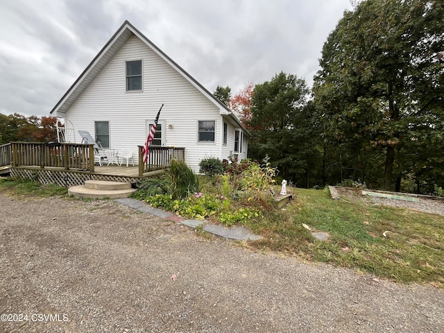 view of home's exterior with a wooden deck