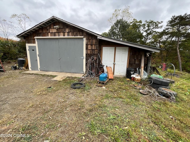 view of outbuilding with an outbuilding and dirt driveway