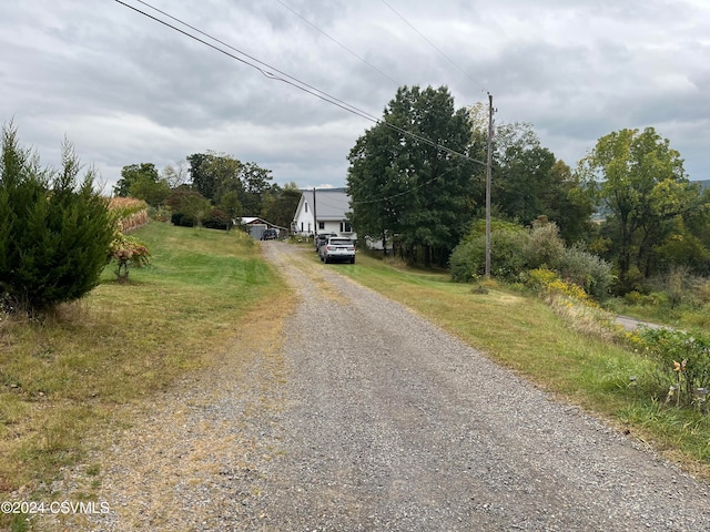 view of road with gravel driveway