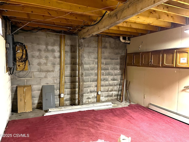 unfinished basement featuring a baseboard radiator and electric panel