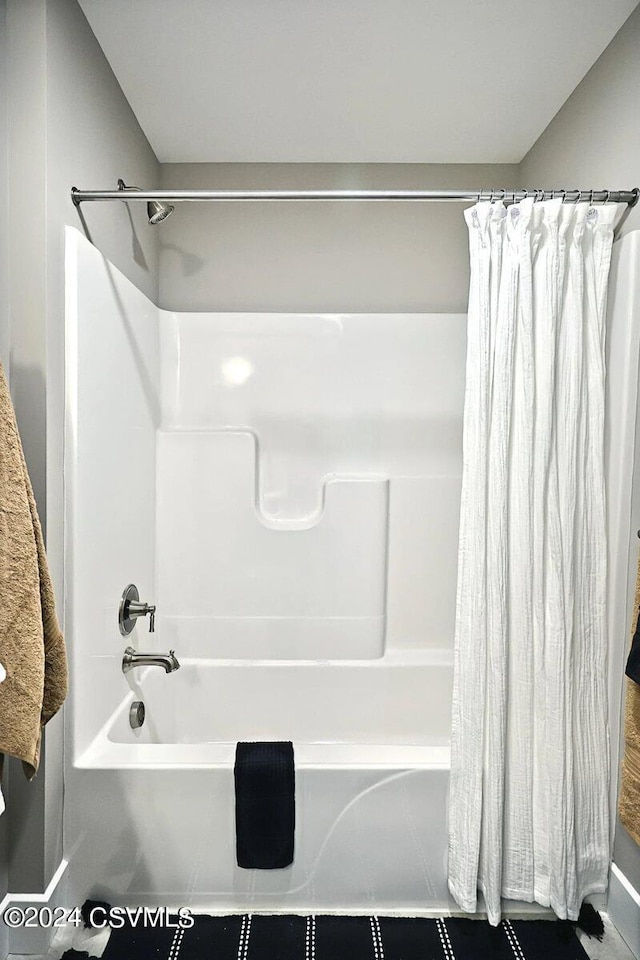 bathroom with shower / tub combo with curtain and tile patterned floors