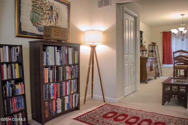 sitting room with a chandelier and carpet floors