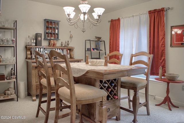 dining area featuring a chandelier and light colored carpet