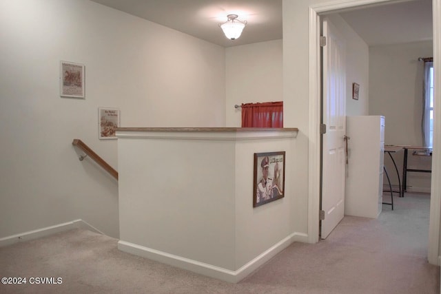 hall featuring light colored carpet