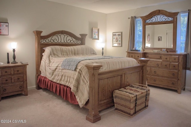 bedroom featuring light carpet