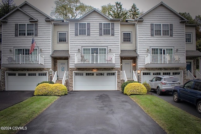 view of front of home with a balcony and a garage