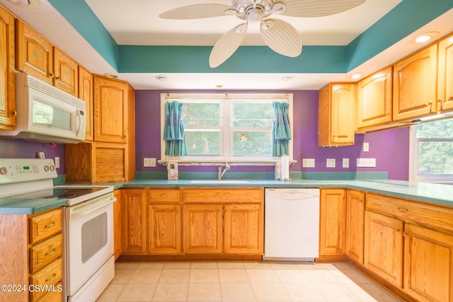 kitchen featuring white appliances, sink, and ceiling fan