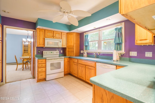 kitchen featuring ceiling fan with notable chandelier, hanging light fixtures, sink, and white appliances