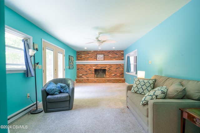 carpeted living room with brick wall, a fireplace, ceiling fan, french doors, and a baseboard heating unit