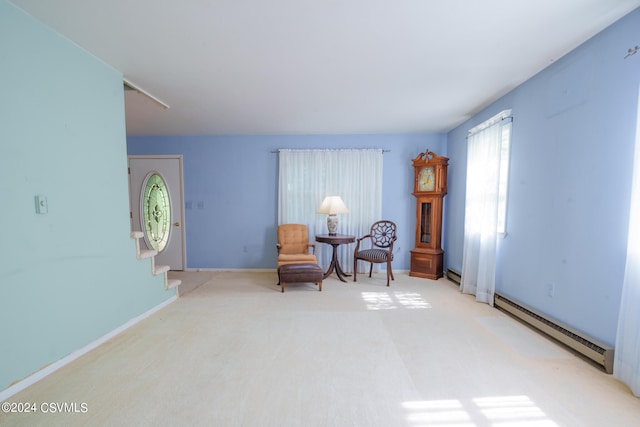 living area featuring a baseboard radiator and carpet flooring