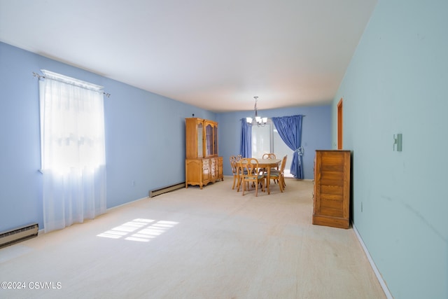 dining space with carpet floors, an inviting chandelier, and a baseboard heating unit