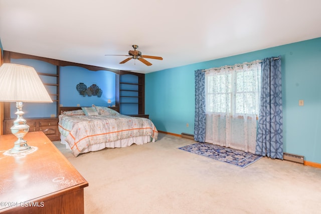 carpeted bedroom featuring a baseboard heating unit and ceiling fan