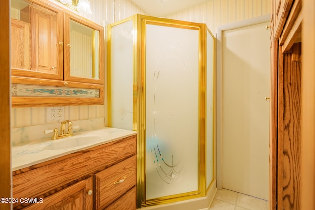 bathroom with walk in shower, tile patterned flooring, and vanity