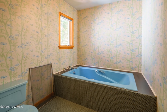 bathroom with tiled tub and toilet