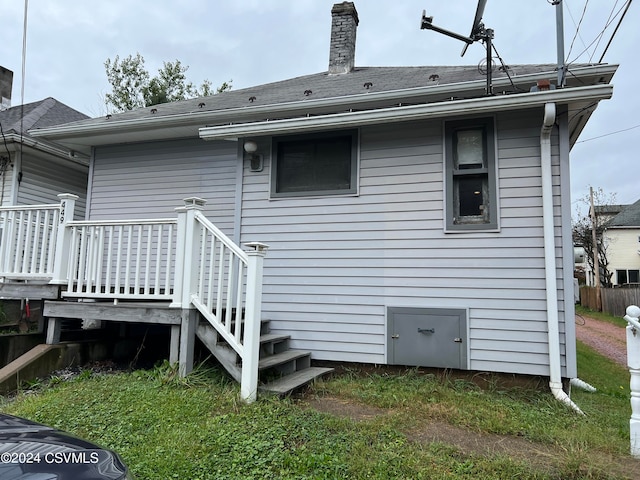 back of property featuring a wooden deck