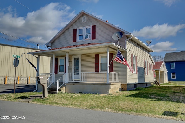 bungalow-style home featuring a front lawn and covered porch