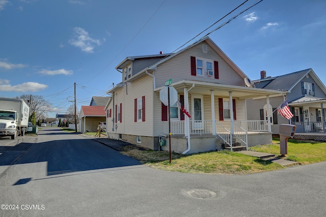 view of front facade with a front yard and covered porch