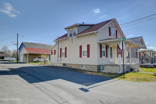 view of property exterior featuring a carport and covered porch