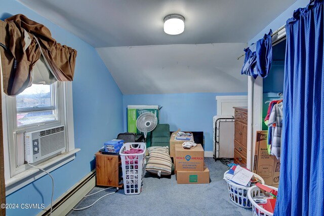 interior space featuring carpet floors, cooling unit, a baseboard radiator, and lofted ceiling