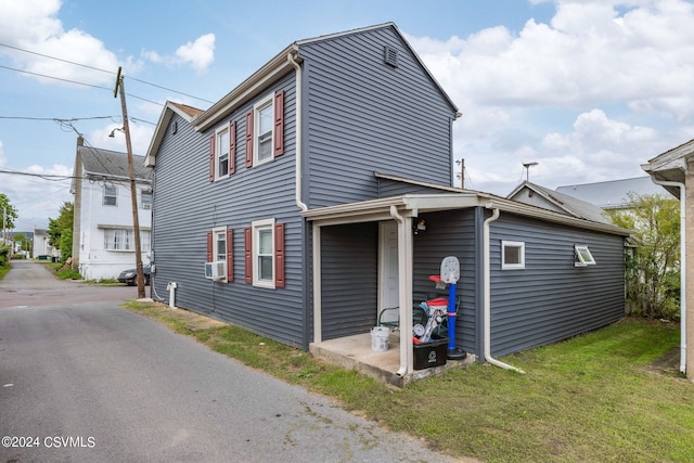 exterior space featuring cooling unit and a yard