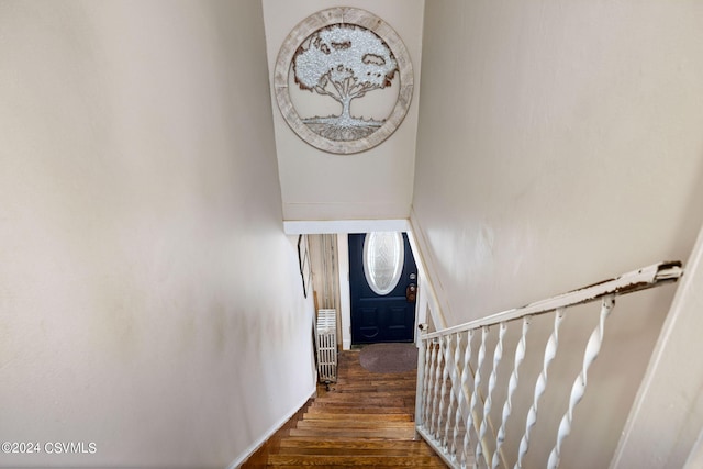 stairs featuring hardwood / wood-style floors