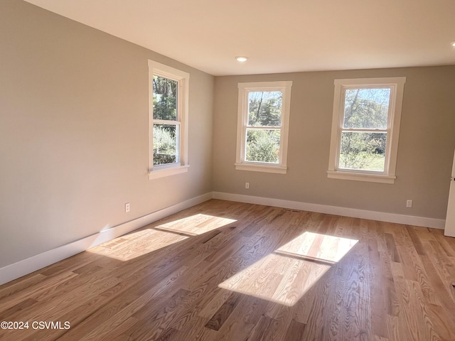 unfurnished room with light hardwood / wood-style floors