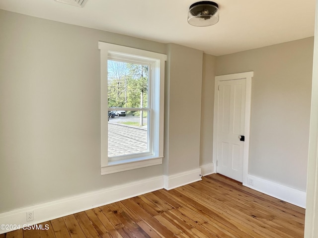 unfurnished room with wood-type flooring