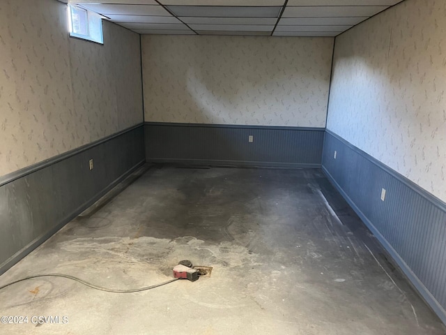 basement with a paneled ceiling