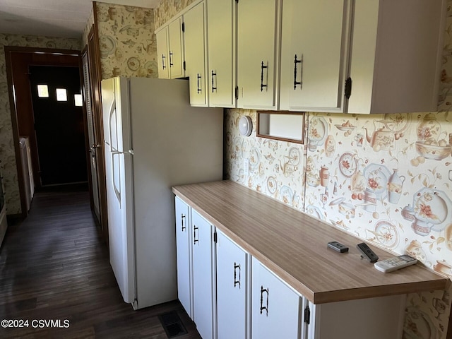 kitchen featuring white refrigerator, white cabinetry, and dark wood-type flooring