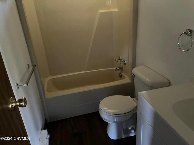 full bathroom featuring hardwood / wood-style floors, vanity, a baseboard heating unit, toilet, and tub / shower combination