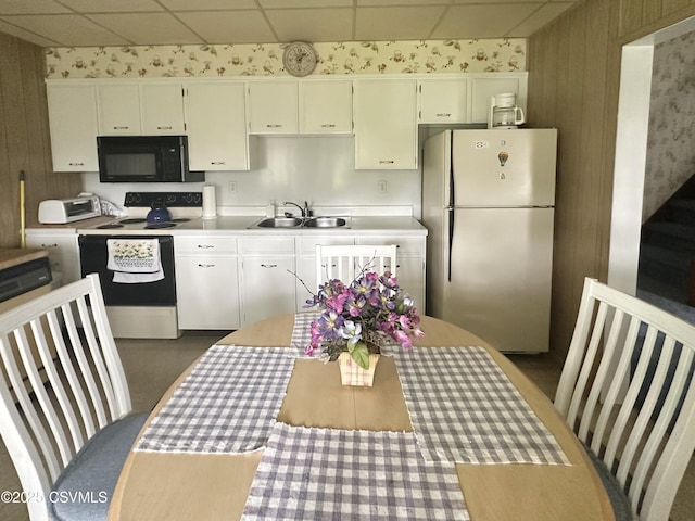 1442 Hemlock St, Coal Township, PA 17866 - kitchen with freestanding refrigerator, black microwave, range with electric cooktop, a paneled ceiling, and light countertops