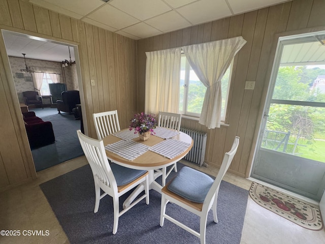 1442 Hemlock St, Coal Township, PA 17866 - dining space featuring wood walls, radiator heating unit, and a chandelier